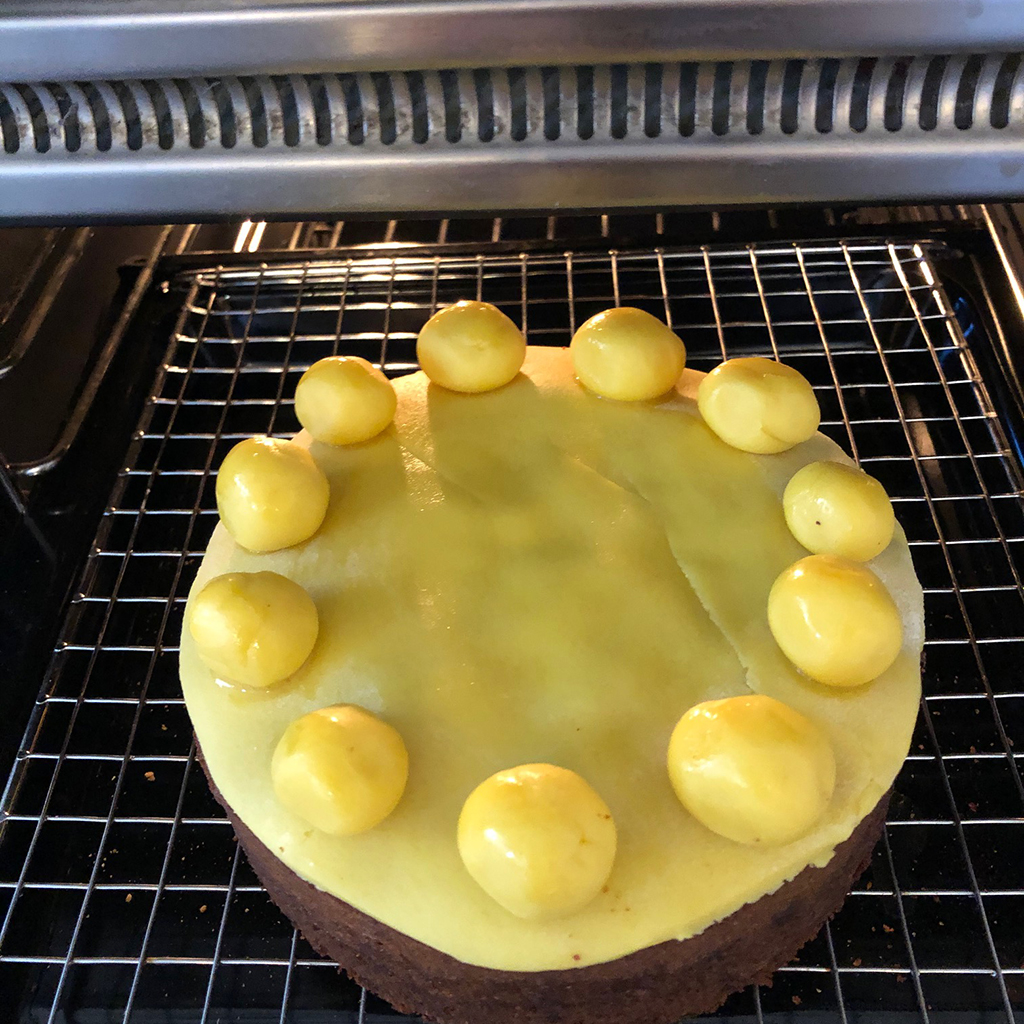Brown simnel cake under grill